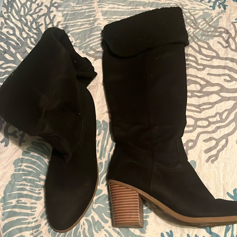 Knee-high black heeled boots, never worn.